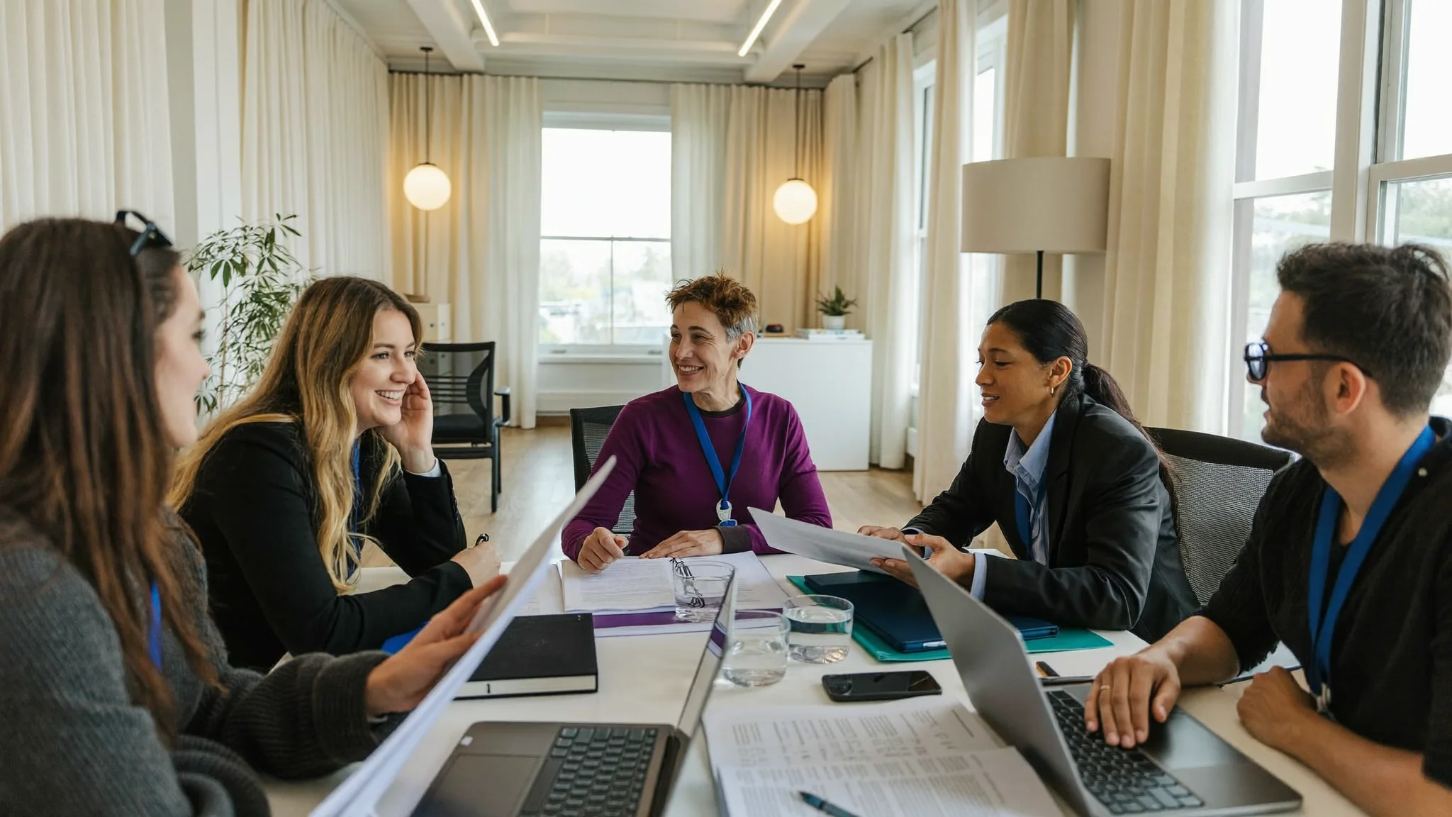 A small team in an engaged discussion around a table (illustrative image)